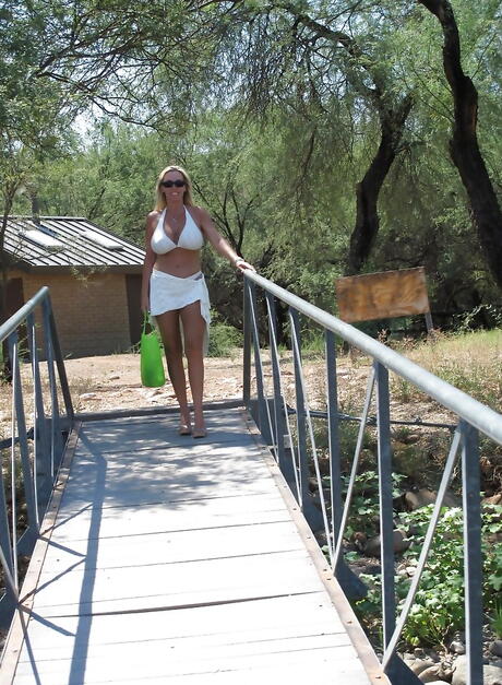 Hot american wife Sandra Otterson exposes big tits and sexy butt outside